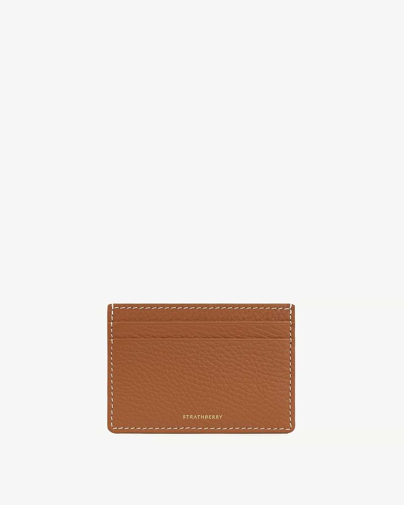 Tan leather cardholder with vanilla stitching and small gold Strathberry logo.