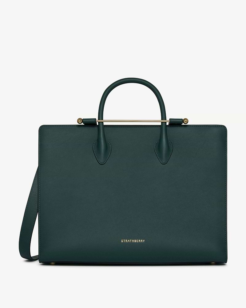 Bottle green leather tote with gold top bar, rounded handles and Strathberry logo.