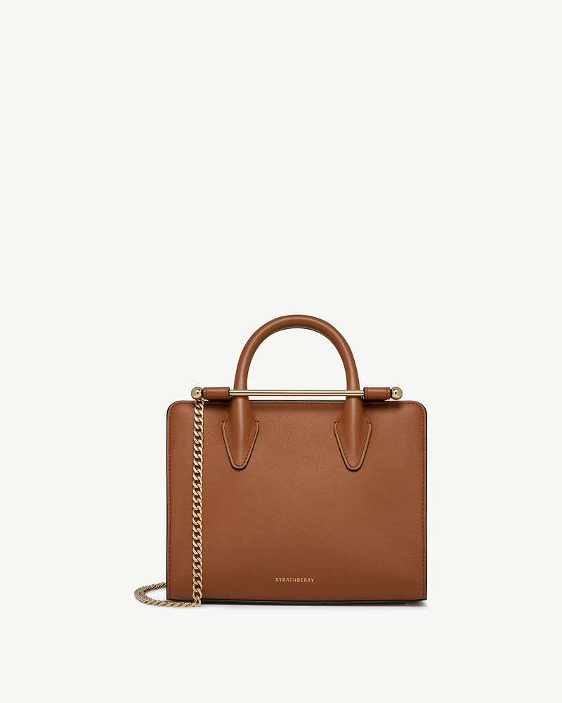 Chestnut Strathberry mini tote with top handles and gold chain strap.