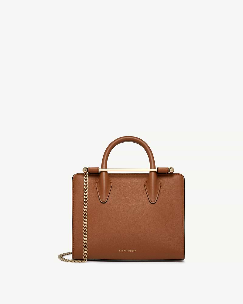 Chestnut Strathberry mini tote with top handles and gold chain strap.