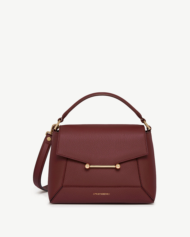 Oxblood Strathberry Mosaic bag with top handle and gold bar detail.