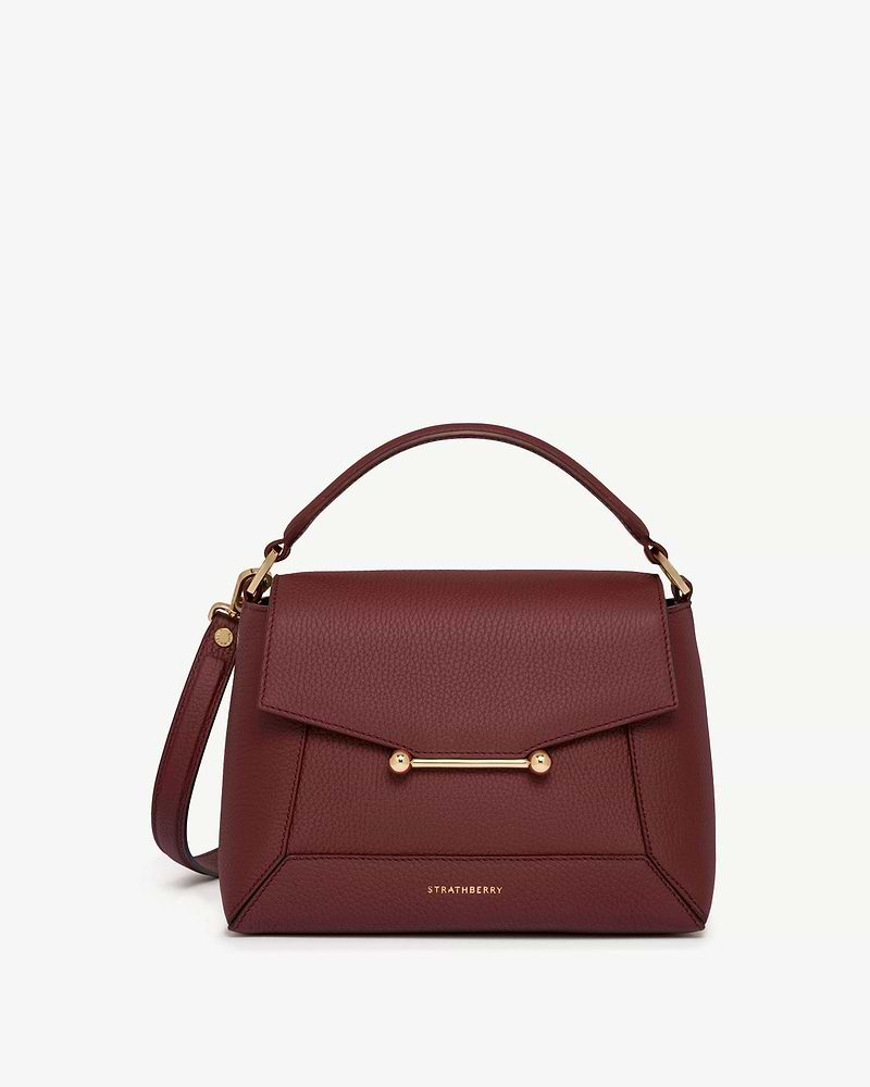 Oxblood Strathberry Mosaic bag with top handle and gold bar detail.