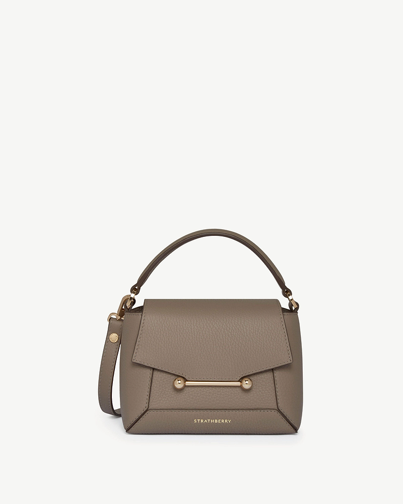 Strathberry Mosaic Nano taupe leather top-handle bag with gold bar detail.