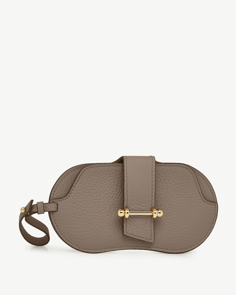 Taupe grained leather sunglasses case with gold bar clasp and wrist strap.