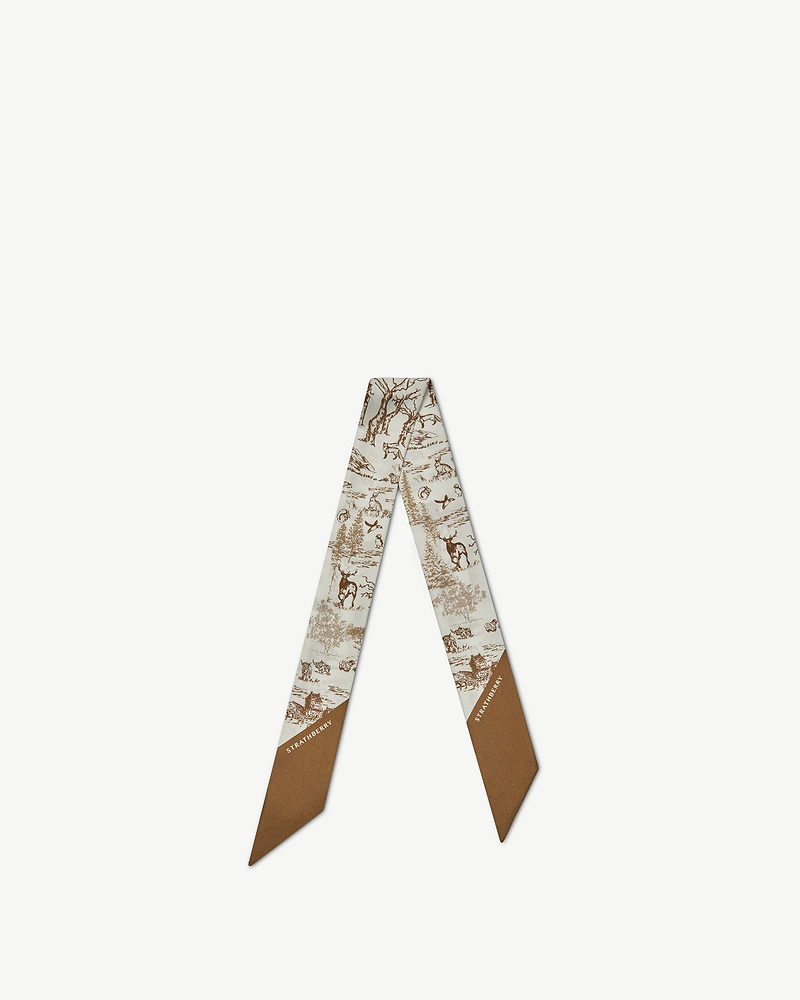 Silk skinny scarf with tan and vanilla animal wallpaper print and Strathberry logo.