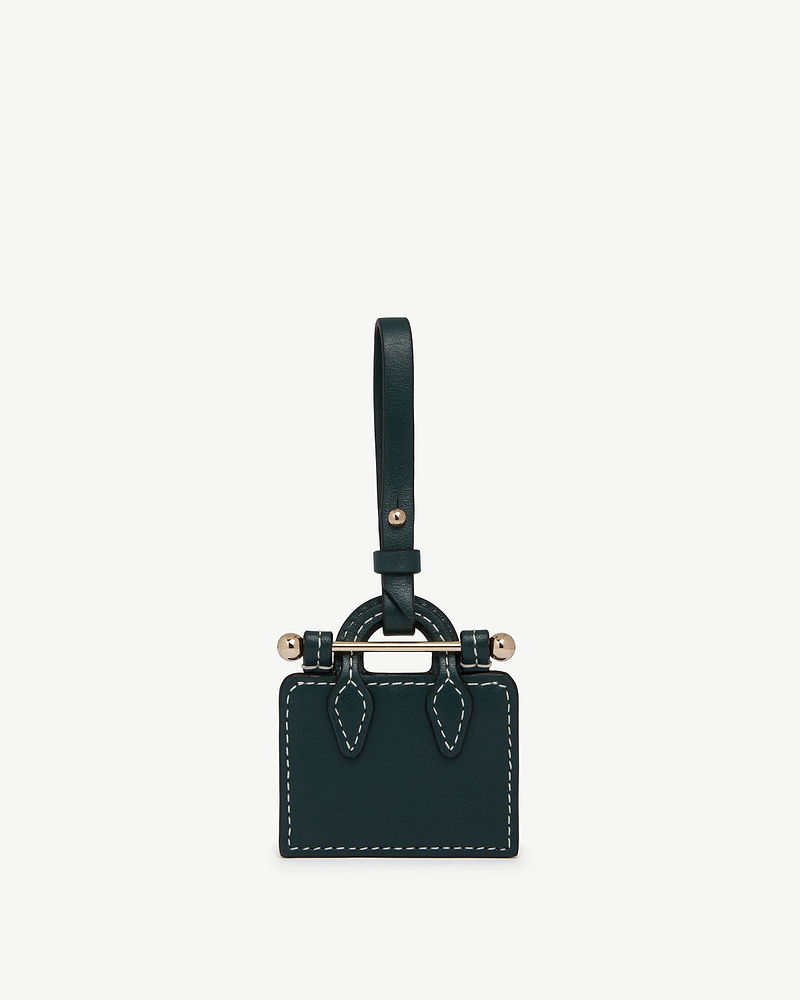 Bottle green leather tote charm with white stitching, gold bar and strap.