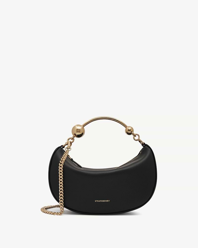 Strathberry Crescent Moon Mini black leather crescent bag with gold chain strap.
