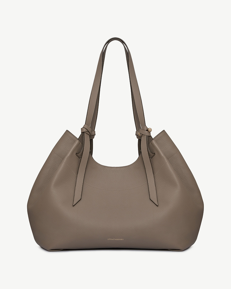 Strathberry Barra tote in taupe pebbled leather with knotted handles and gold logo.