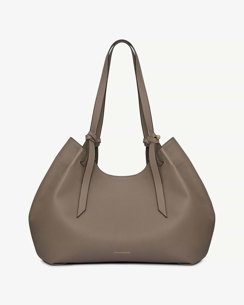 Strathberry Barra tote in taupe pebbled leather with knotted handles and gold logo.