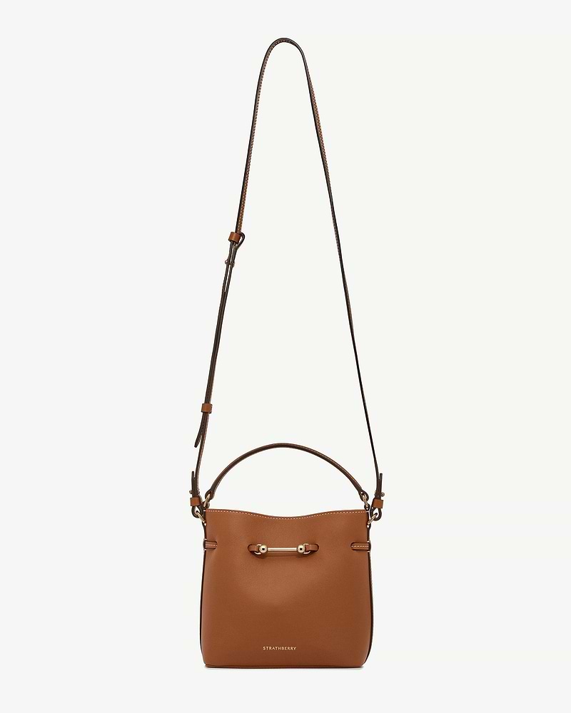 Chestnut leather mini bucket bag with long strap, gold bar hardware, Strathberry logo