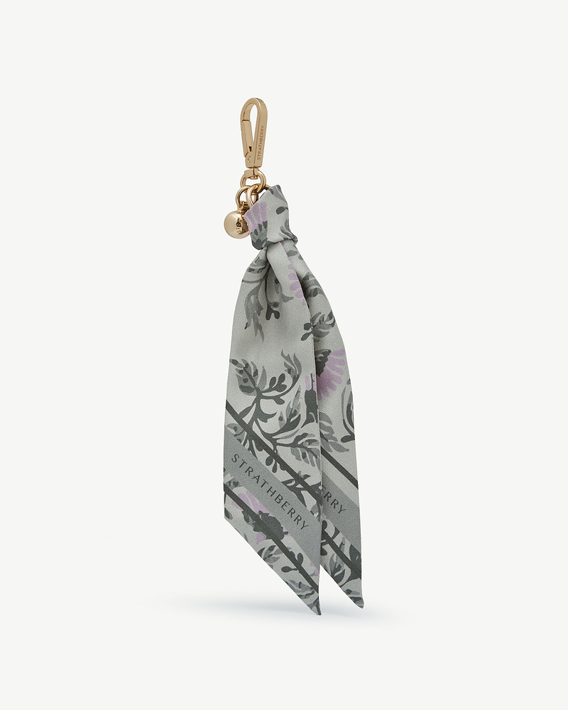 Green thistle-print silk charm with gold Strathberry clasp and logo charm