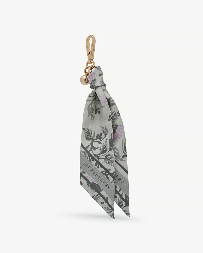 Green thistle-print silk charm with gold Strathberry clasp and logo charm