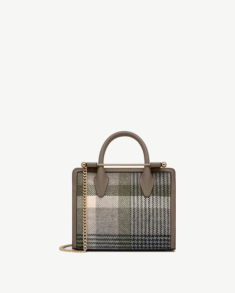 Mini tote with top handles, taupe leather trim and green tartan fabric, gold chain strap.