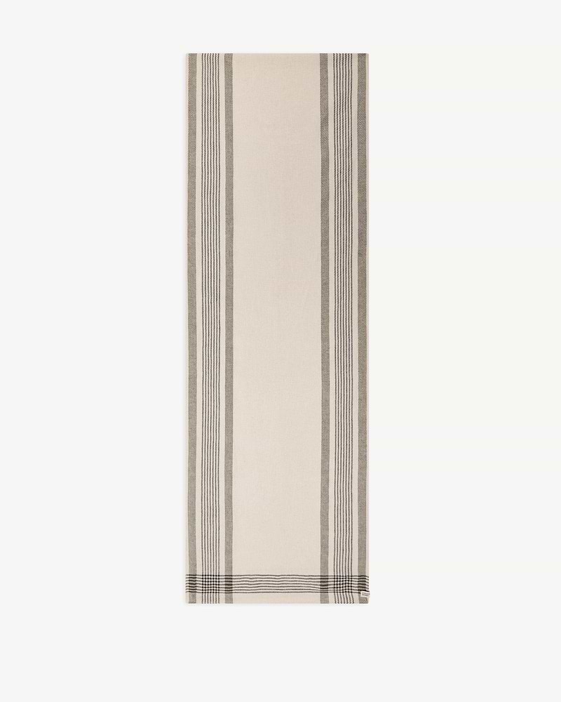 Beige tartan cotton-linen table runner with vertical dark stripes and Strathberry tag.