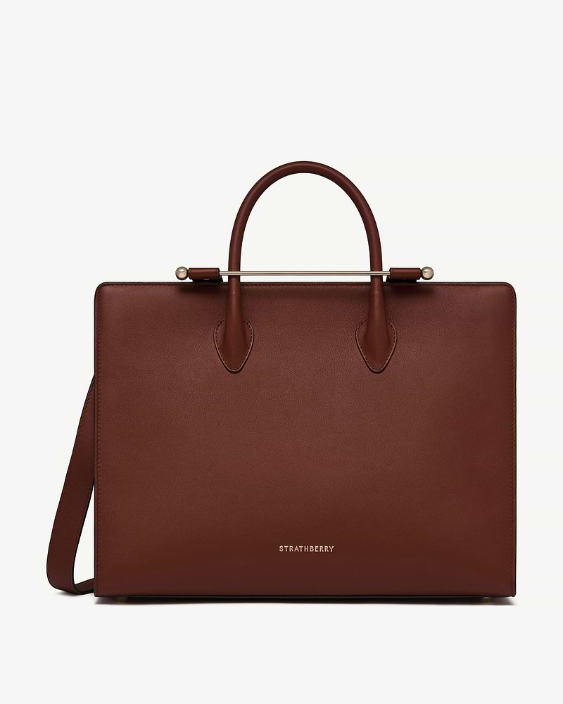 Walnut leather tote with top handles, gold bar and Strathberry logo.