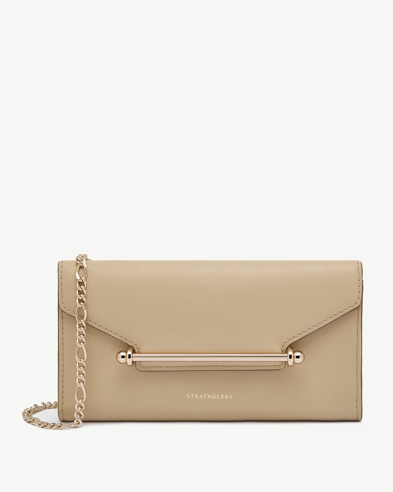 Strathberry chain wallet in sand with gold bar and chain.