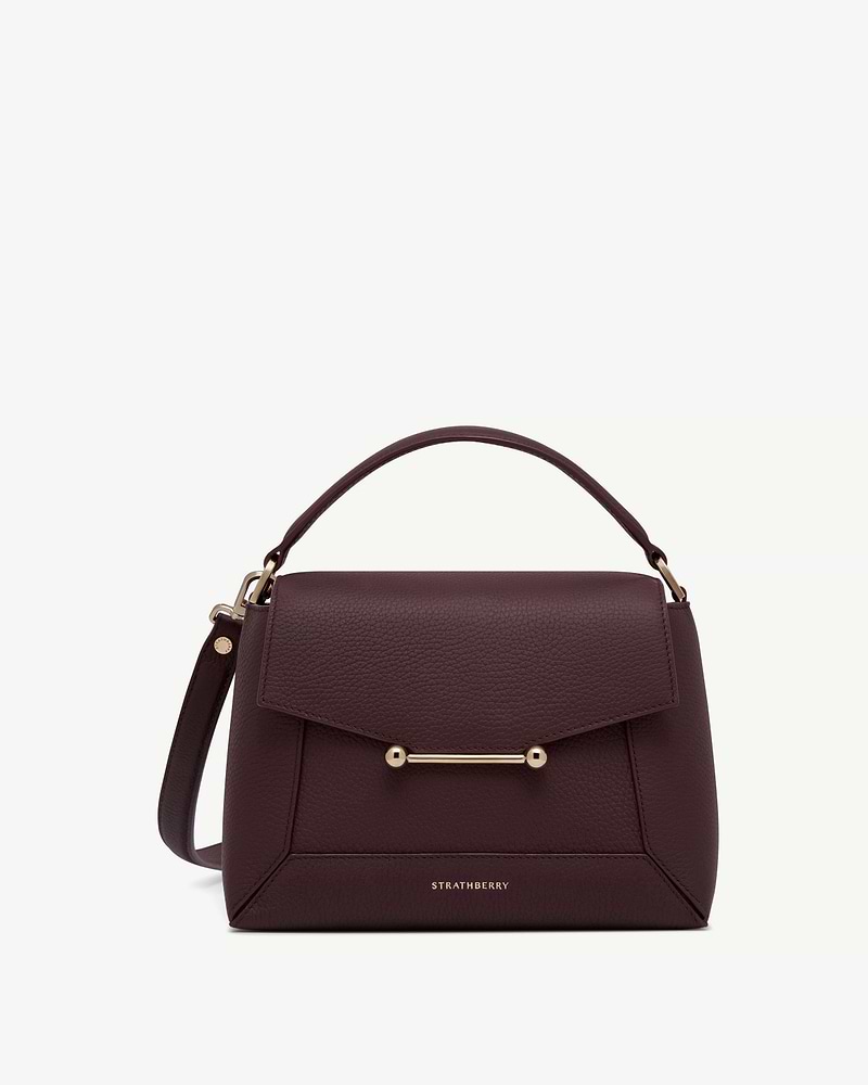 Burgundy mosaic top handle bag with gold bar detail and Strathberry logo.