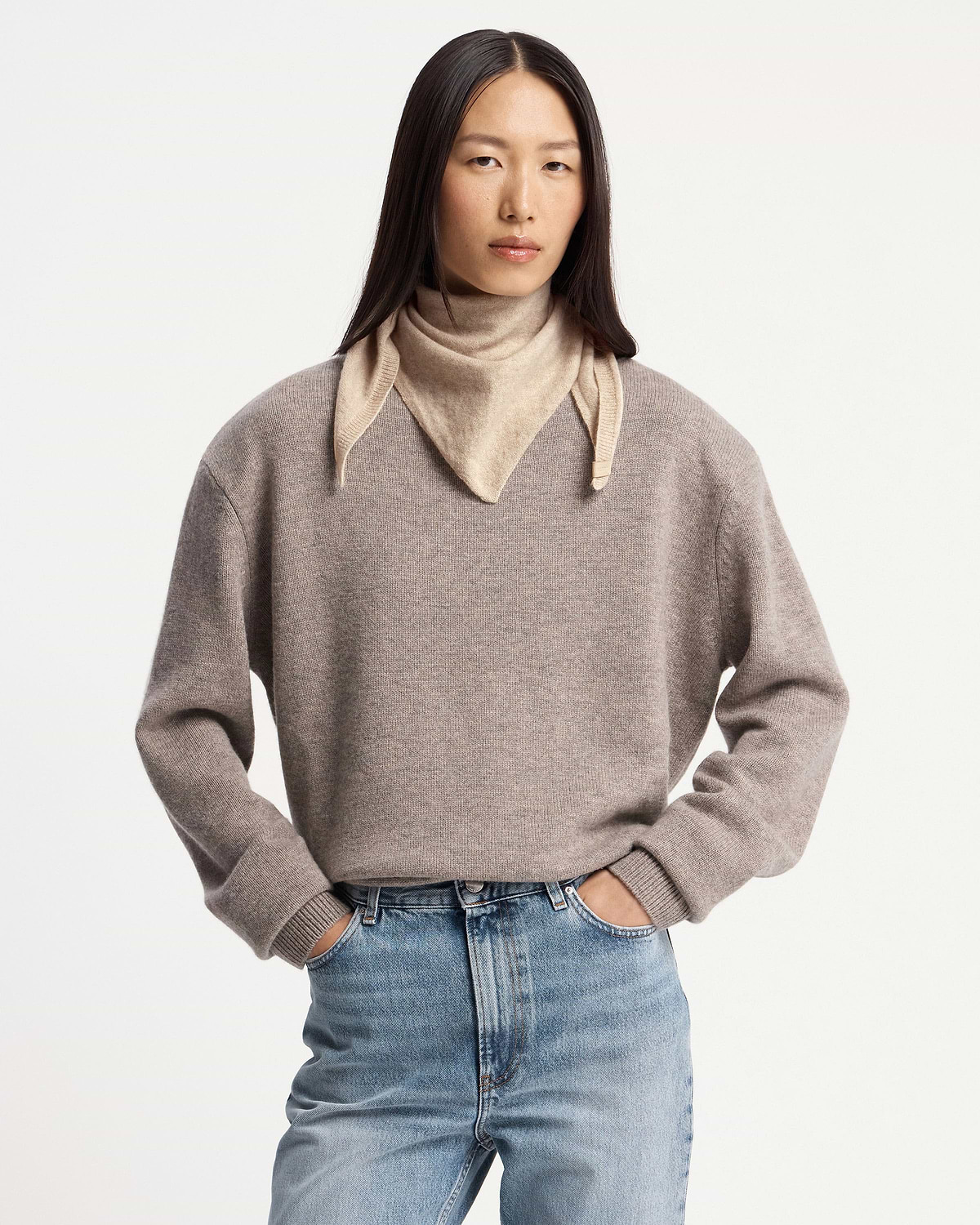 Model wearing an oat-coloured cashmere bandana tied around her neck.