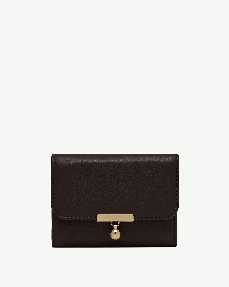 Espresso leather trifold wallet with gold bar clasp and charm on white background.