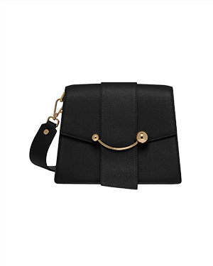 Black box crescent bag with front vertical tab, gold crescent bar, and detachable shoulder strap.