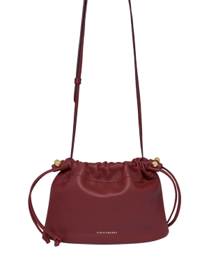 Oxblood leather Charlotte drawstring bag with adjustable strap and Strathberry logo.