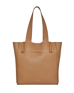 Caramel leather tote bag with long shoulder straps and minimalist gold hardware.