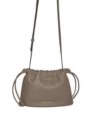 Taupe Strathberry Charlotte drawstring crossbody bag with adjustable strap and knotted side ties