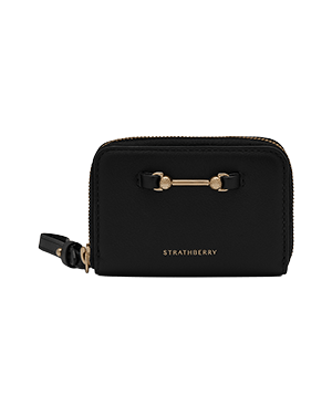 Black Strathberry Corda zip-around wallet with gold bar detail and wrist strap.