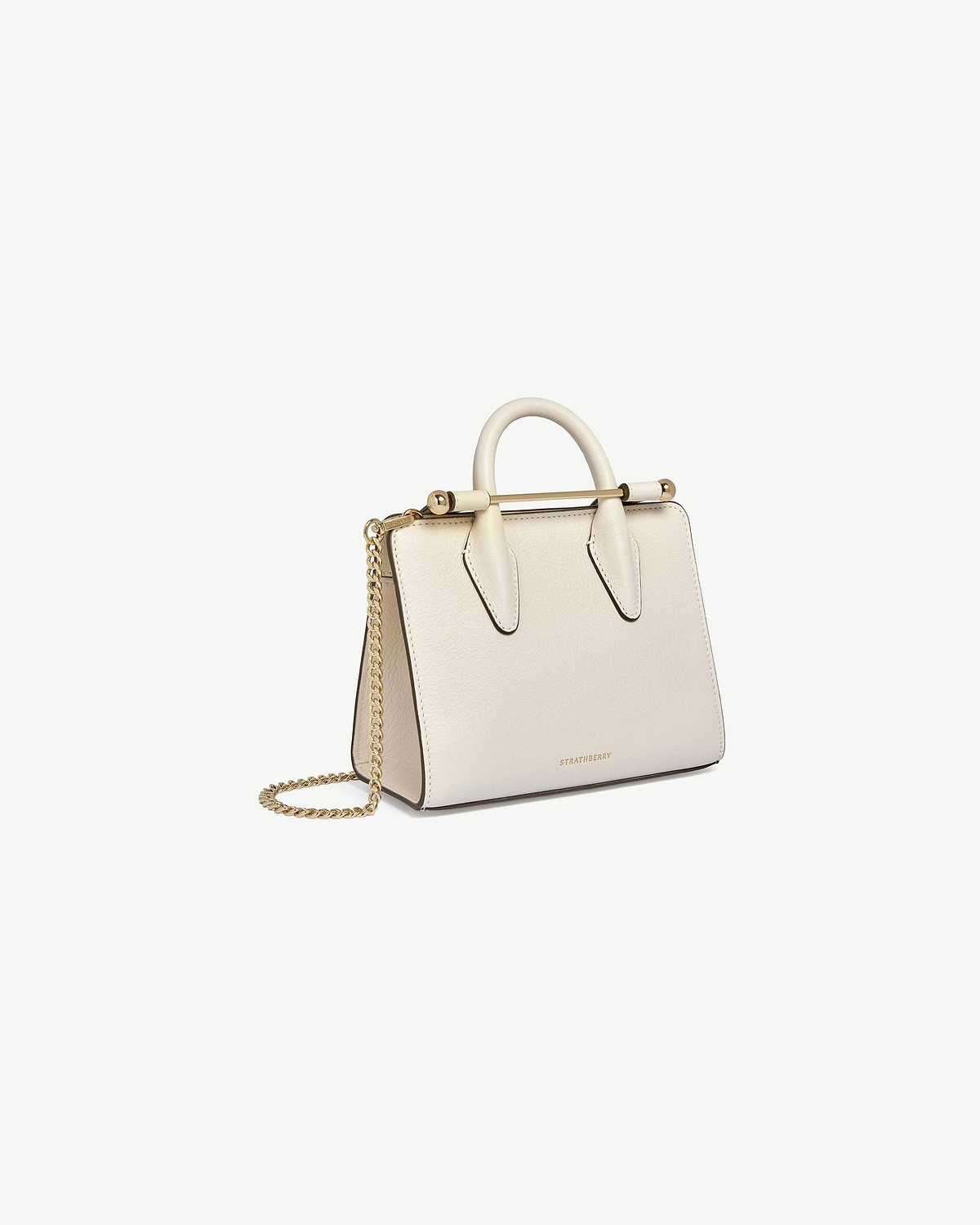 Strathberry nano tote in vanilla leather with top handle and gold chain strap.