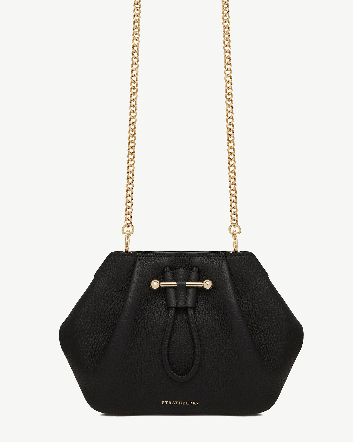 Gold short chain strap attached to Strathberry black pebbled leather crossbody bag.
