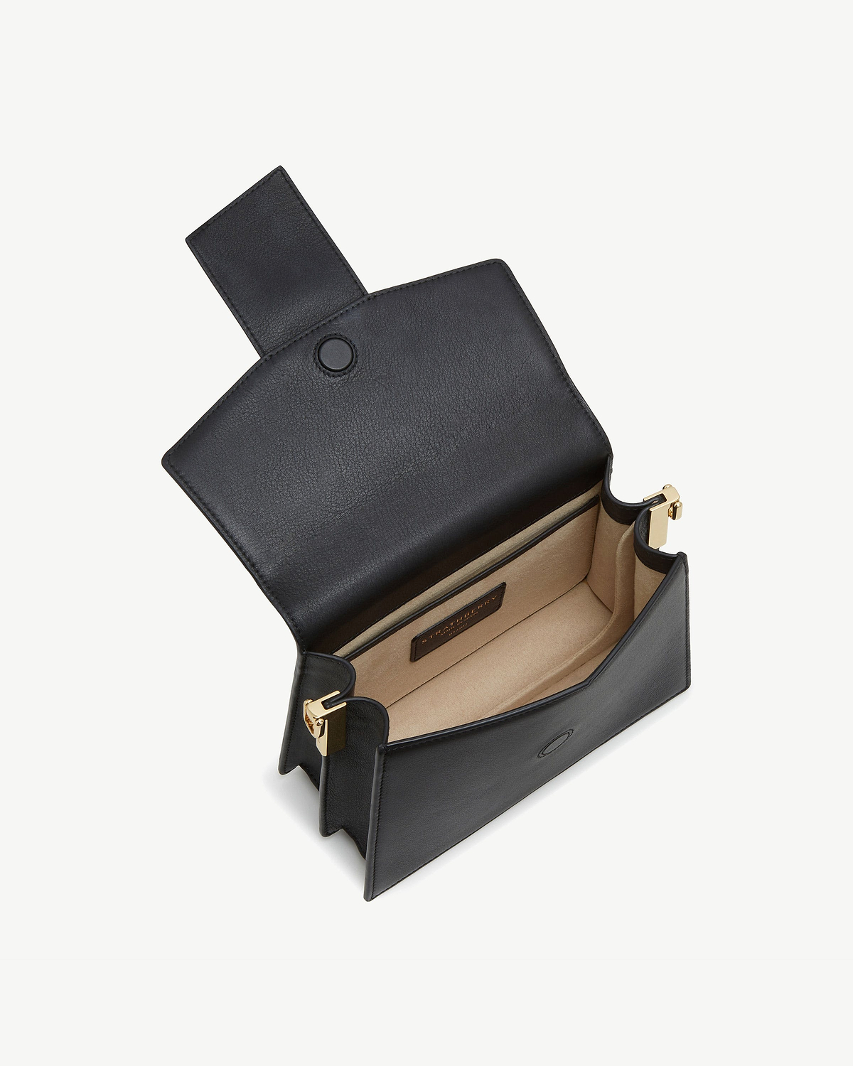 Black Box Crescent bag with flap open, beige interior and gold hardware.