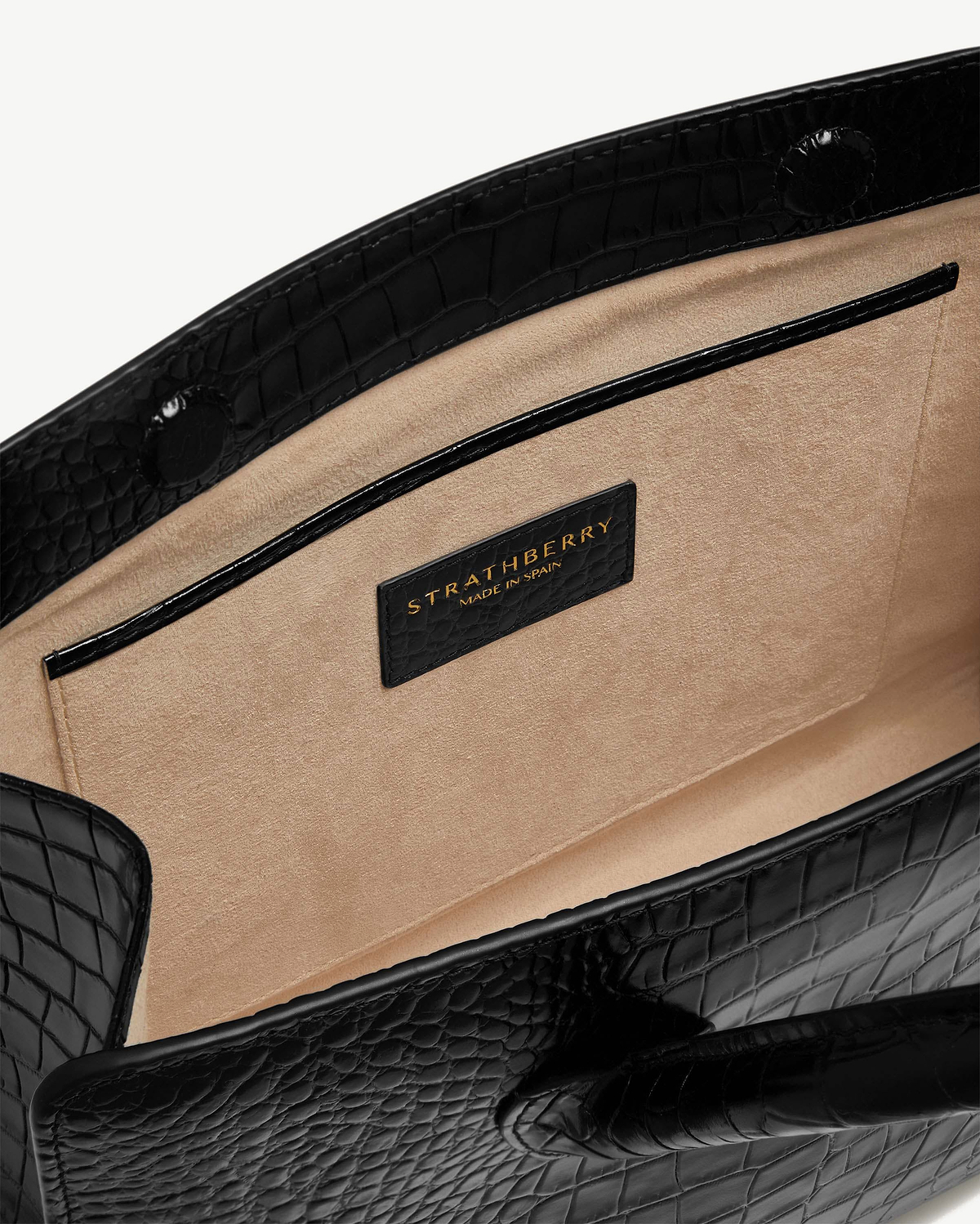 Beige suede interior and pocket of black croc-embossed Strathberry midi tote.