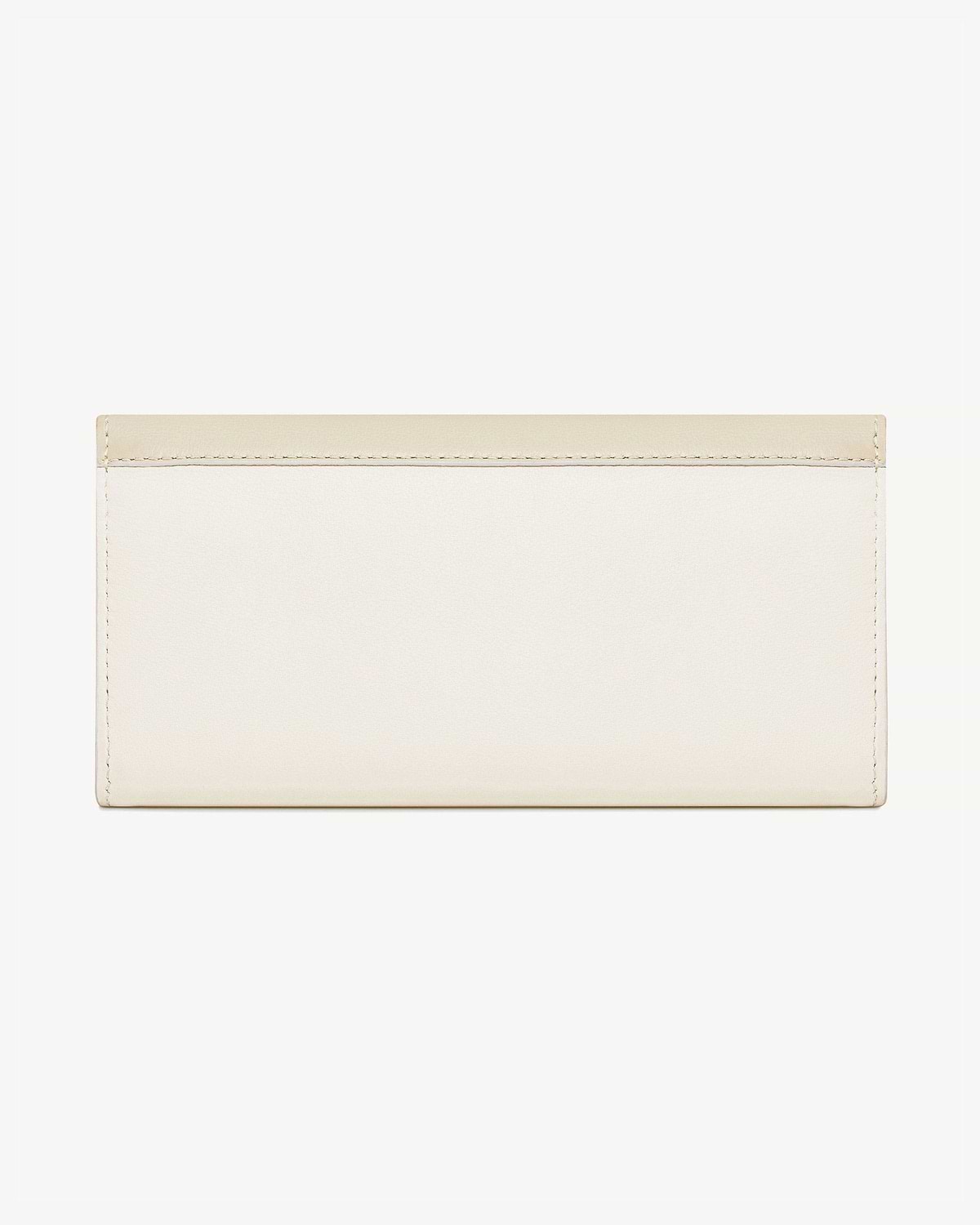 Vanilla and diamond two-tone long wallet with stitched edges on white background.
