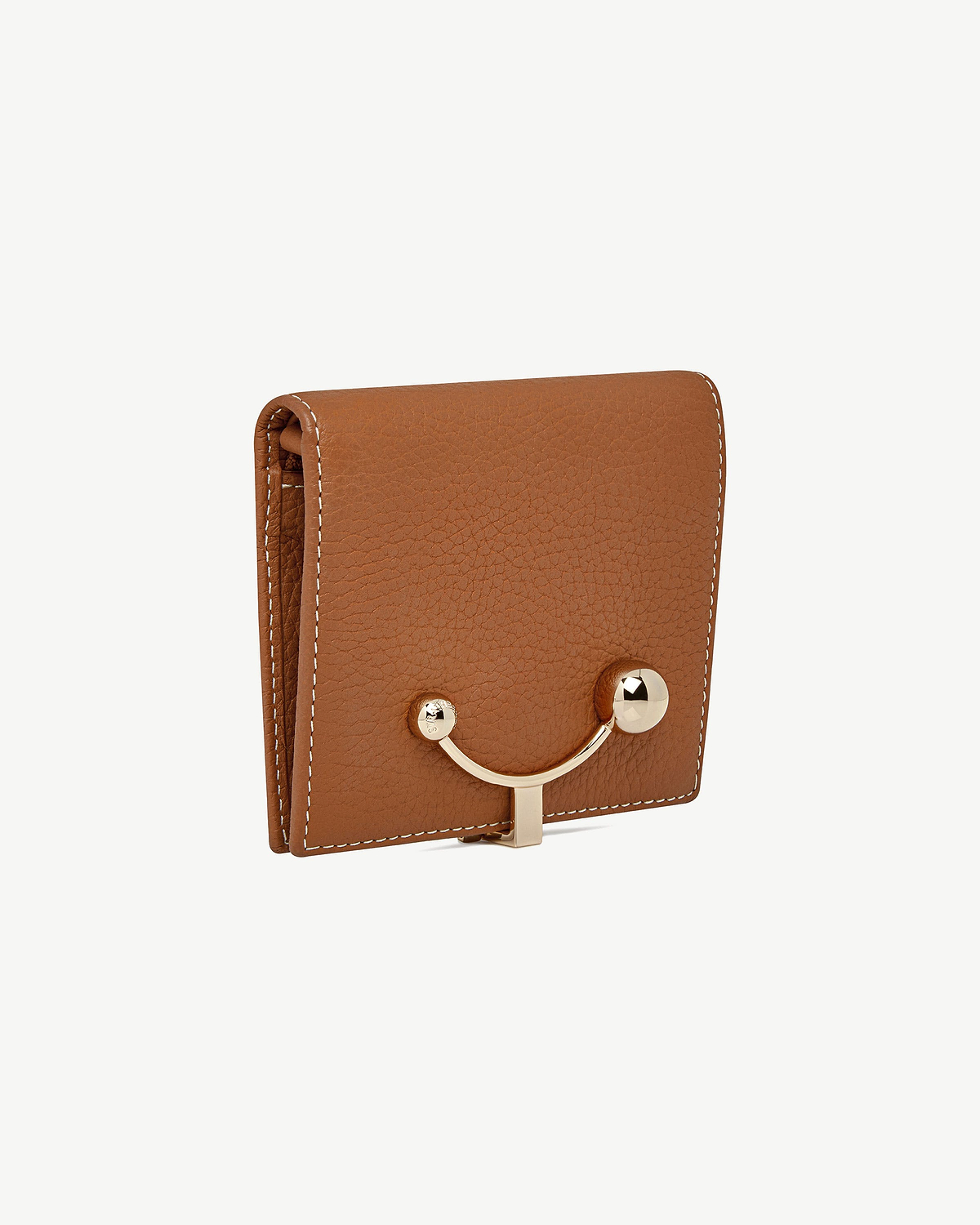 Tan crescent wallet with vanilla stitching and gold curved clasp on front