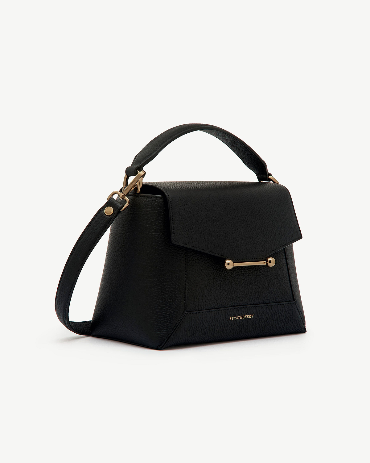 Black mosaic bag with top handle, adjustable shoulder strap, gold bar fastening, Strathberry logo.