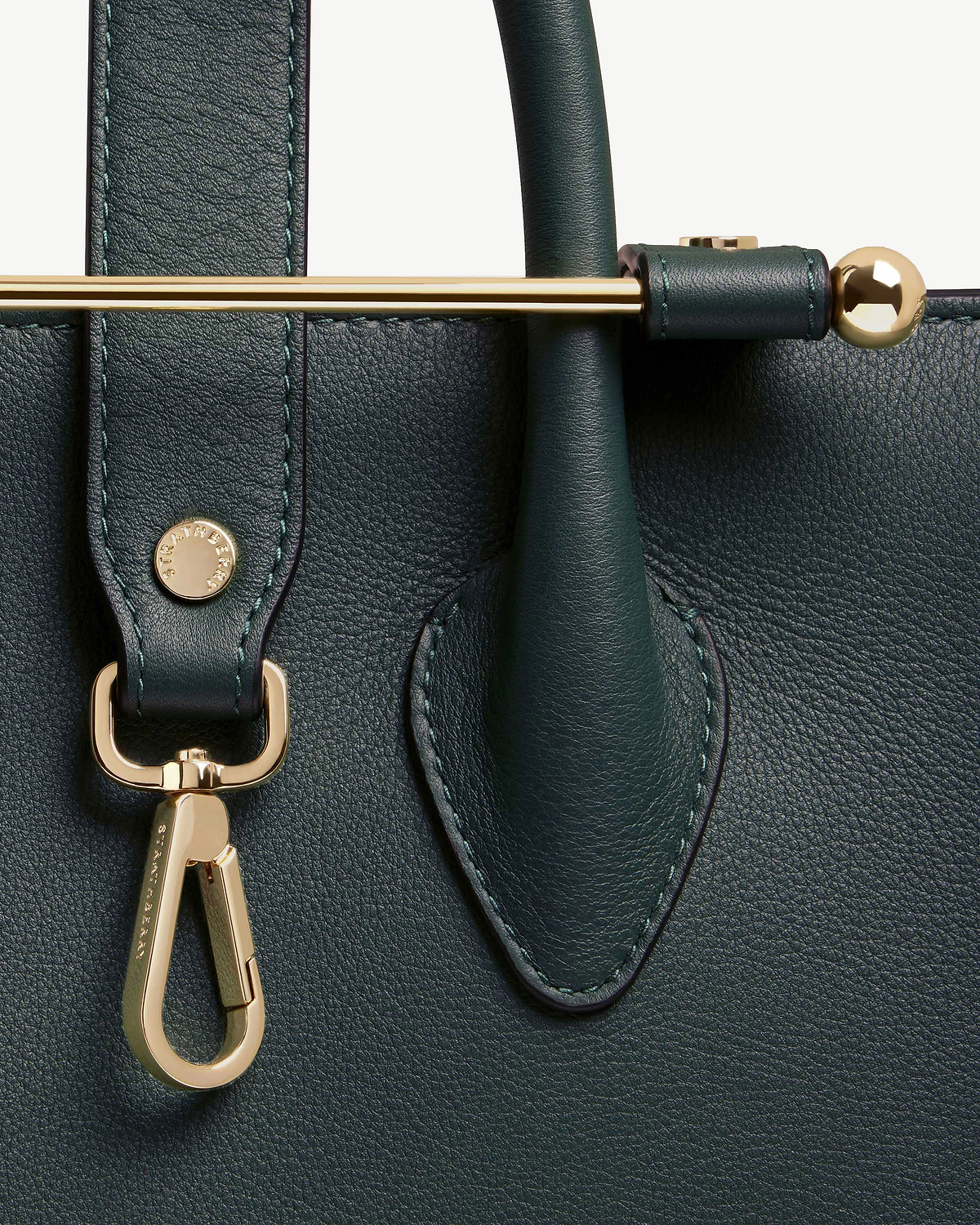 Bottle green leather midi tote with gold bar, clasp and handle detail.