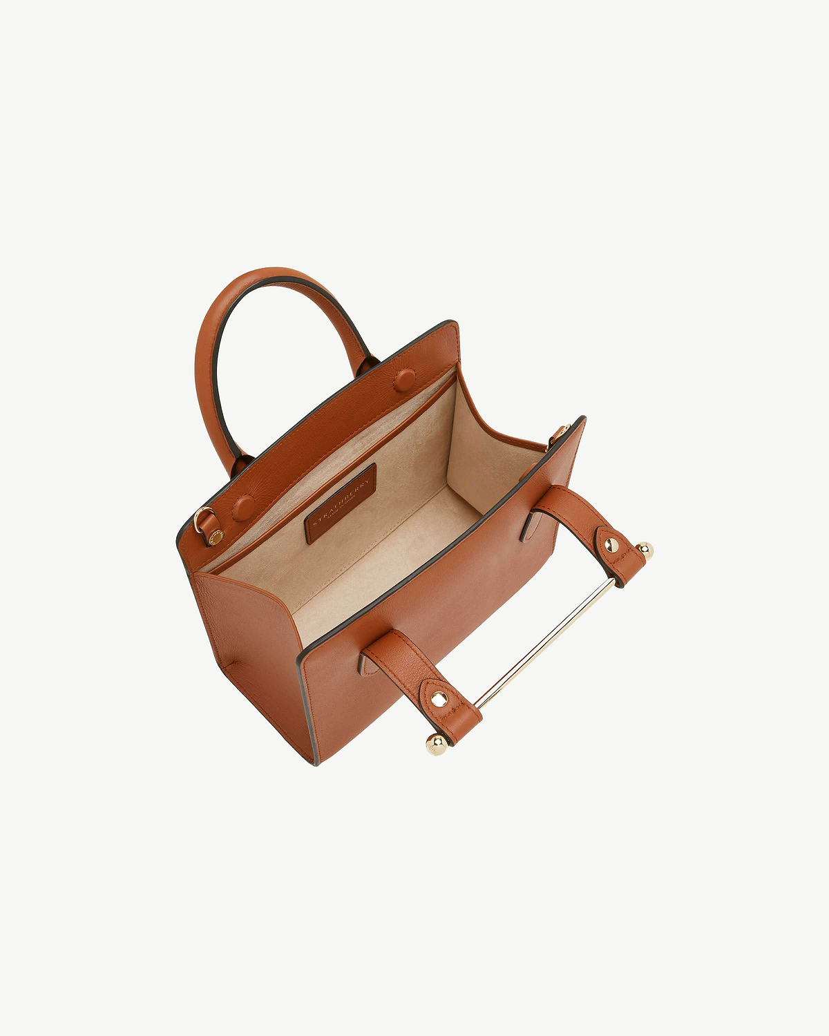 Chestnut mini tote with top handles, open interior and visible brand label