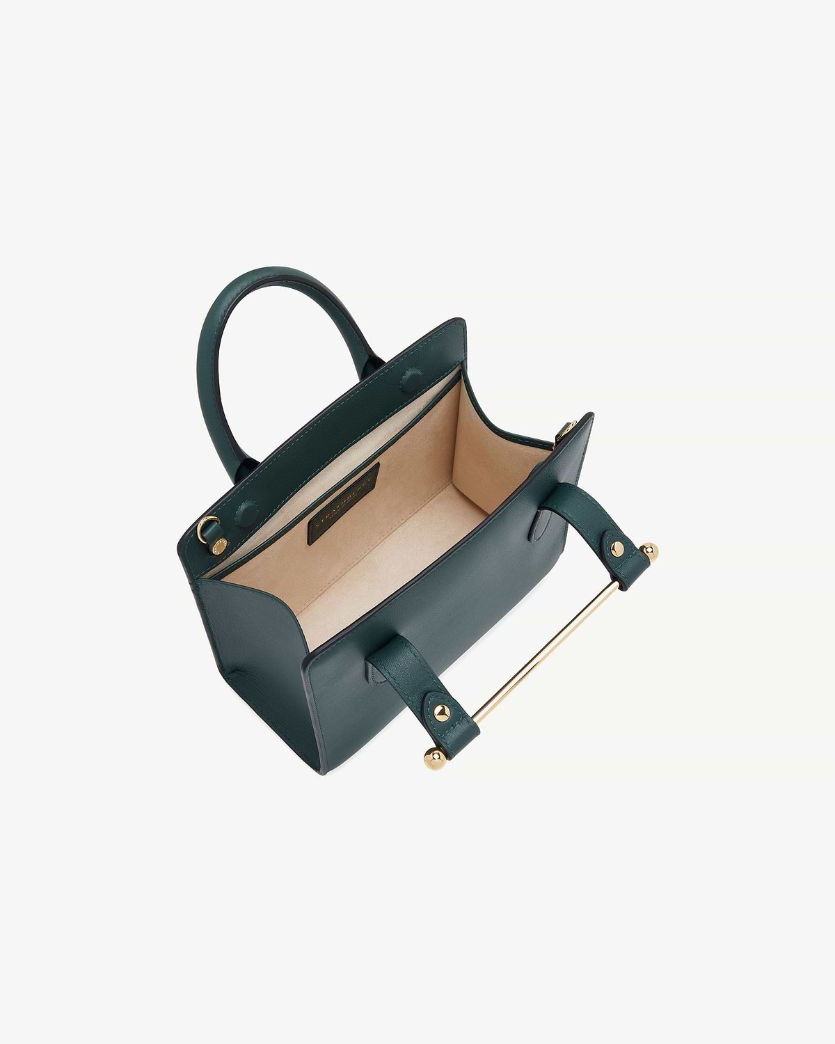 Bottle green mini tote with beige interior, top handles and gold metal bar