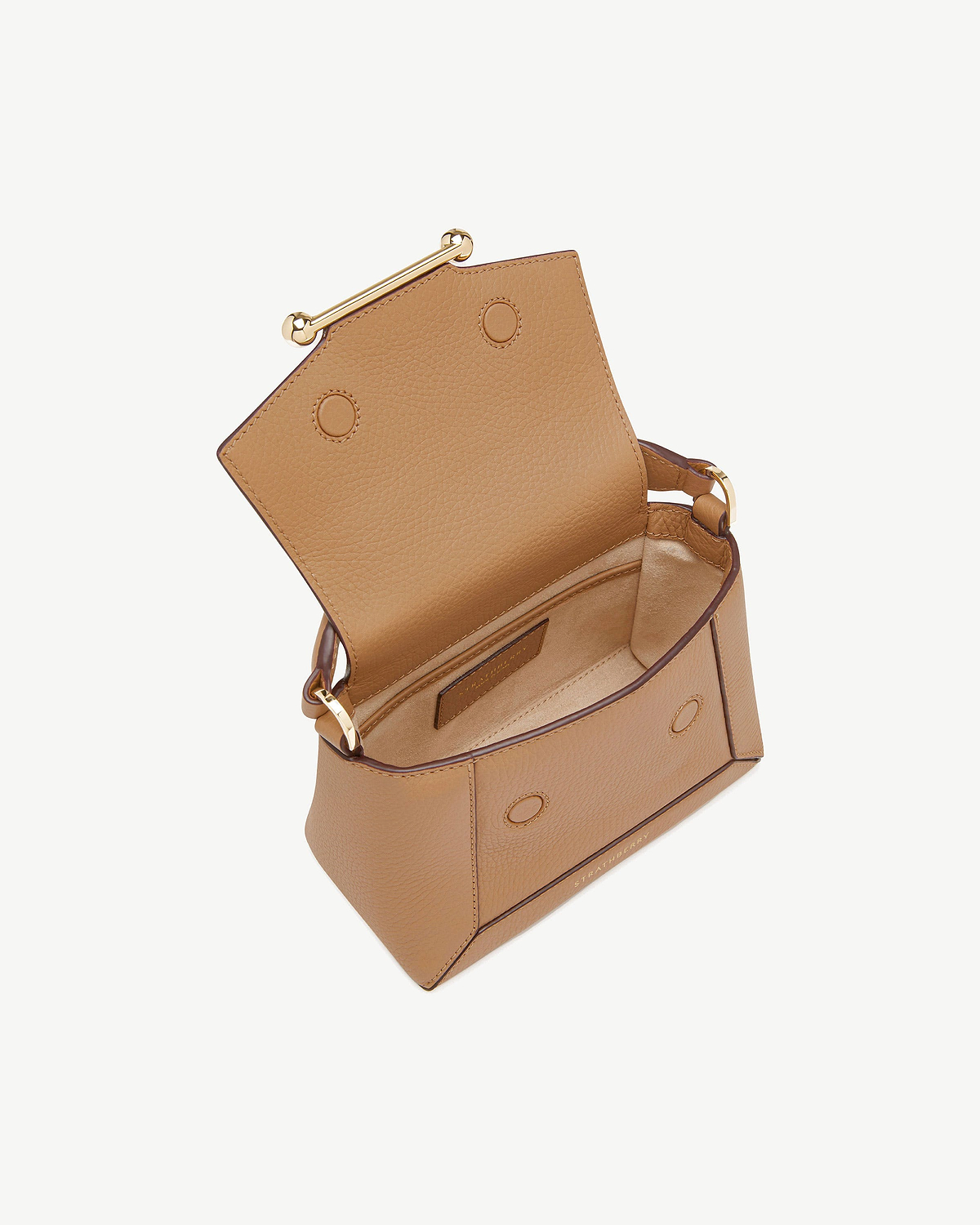 Open Strathberry Mosaic Nano caramel leather bag showing interior and gold bar clasp.