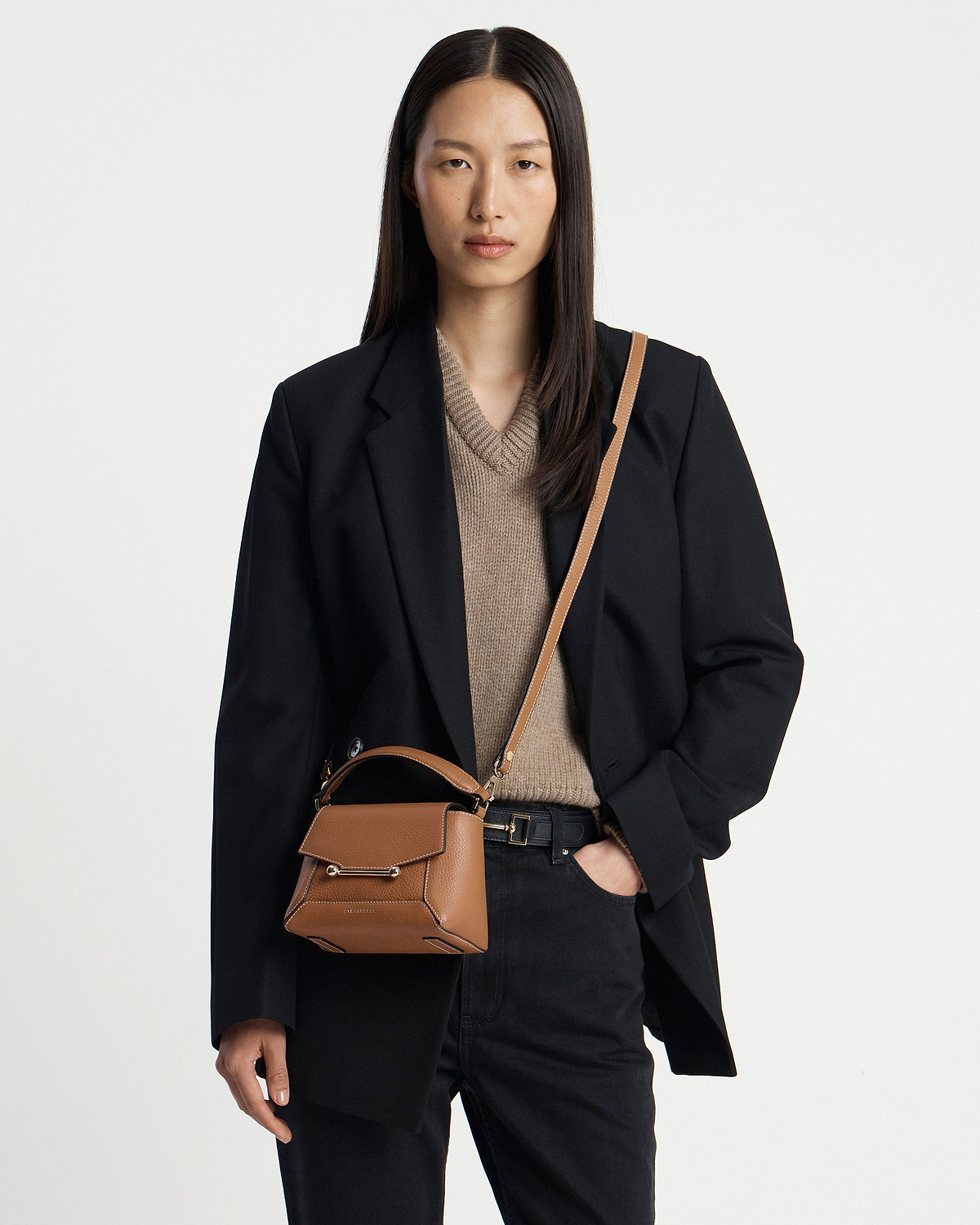 Model wearing tan Mosaic Nano crossbody bag with vanilla stitching and top handle.