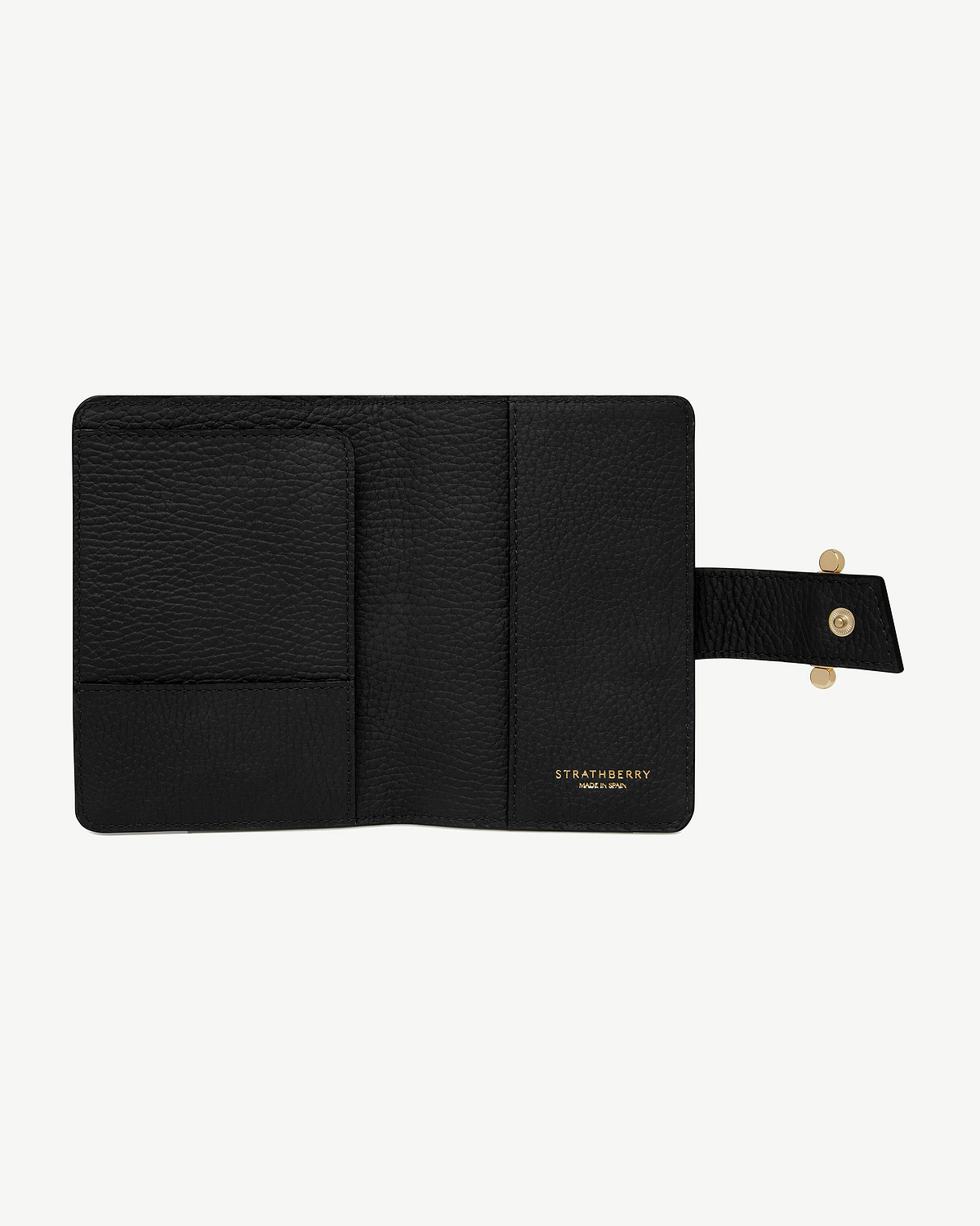 Black Strathberry leather passport holder open, interior pockets and gold logo.
