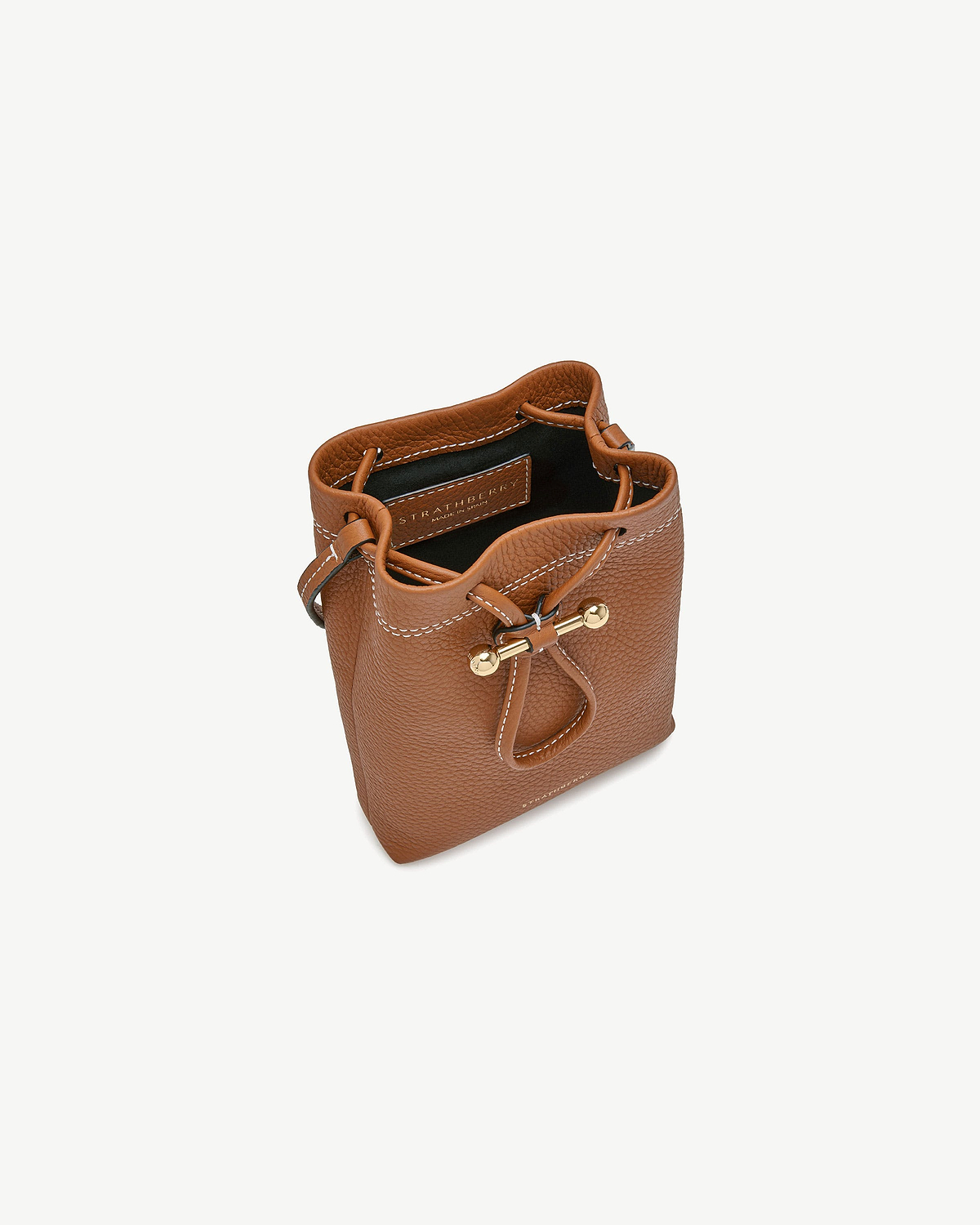 Tan Strathberry Osette midi pouch top view showing drawstring and gold fittings.