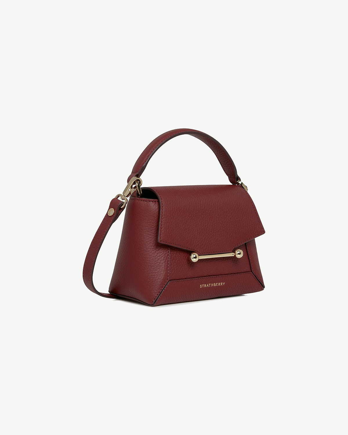 Strathberry Mosaic Nano oxblood leather bag with top handle and gold bar.
