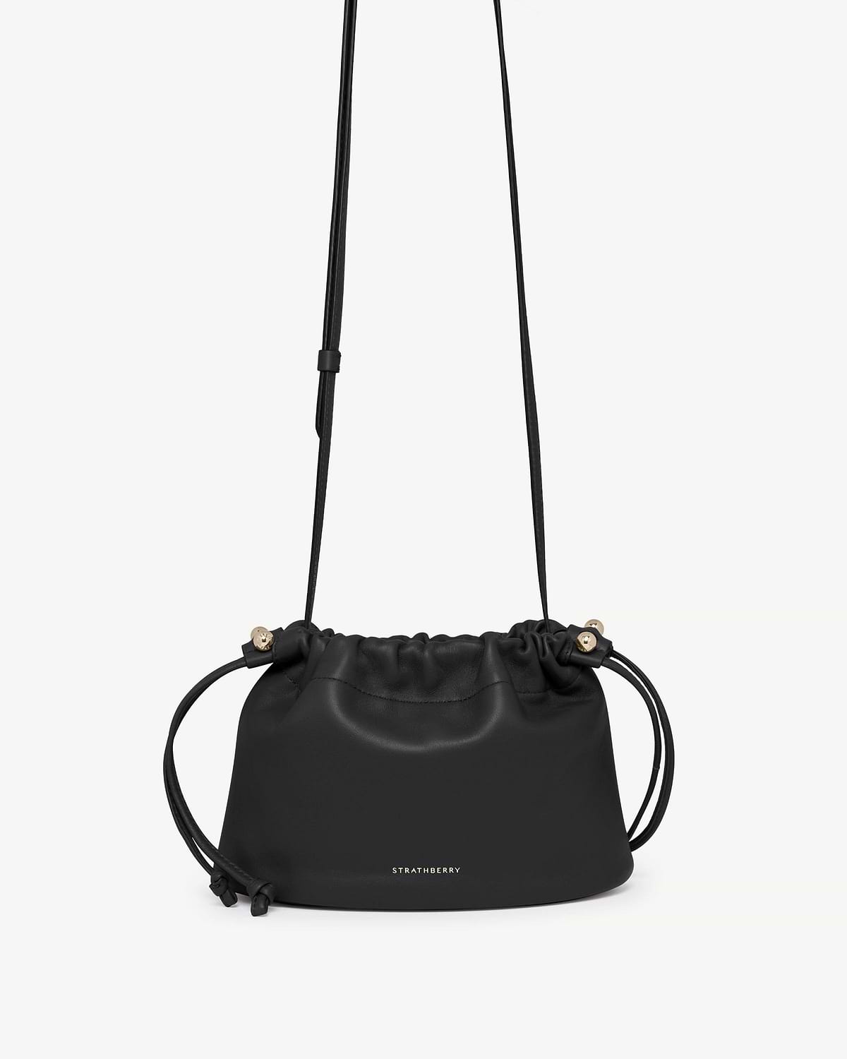 Black Strathberry Charlotte drawstring bag with long shoulder strap and gold hardware.