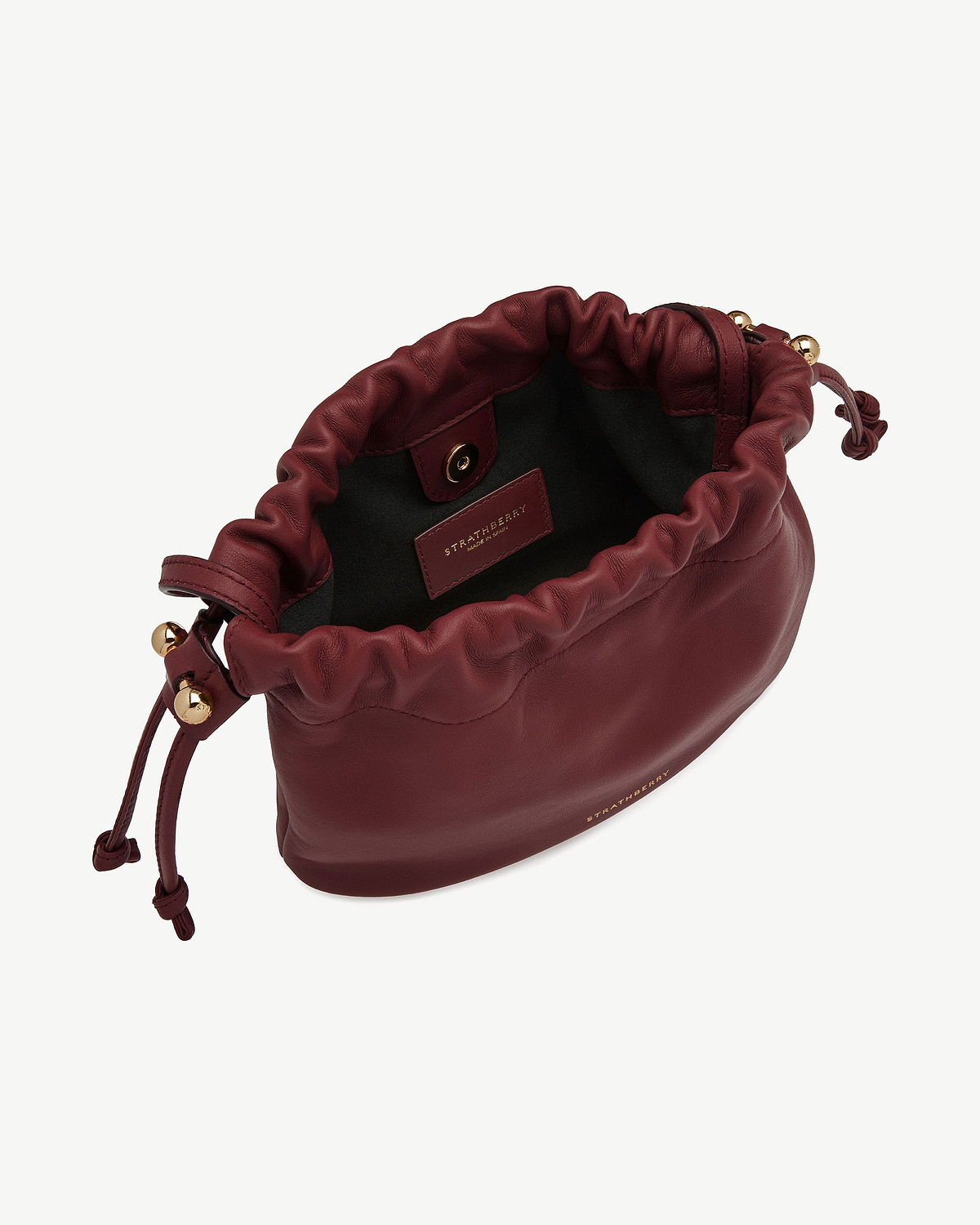 Strathberry Charlotte drawstring bag in oxblood leather with gold hardware