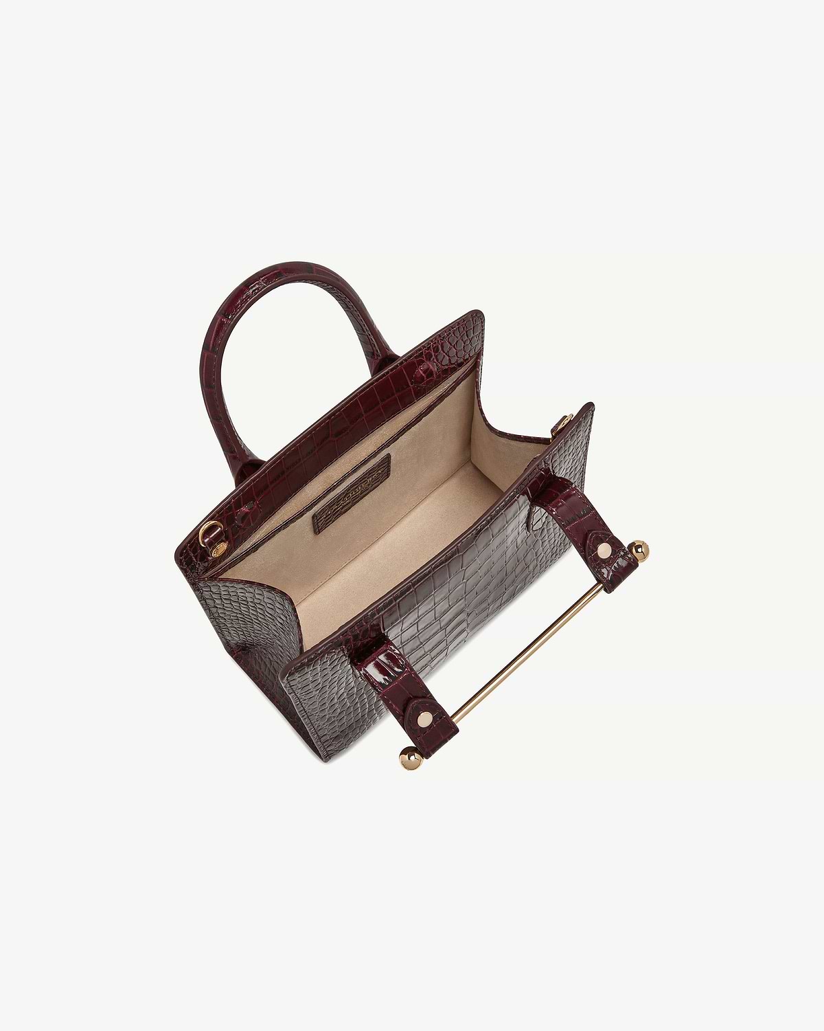 Burgundy croc mini tote with open top showing beige interior and gold bar hardware
