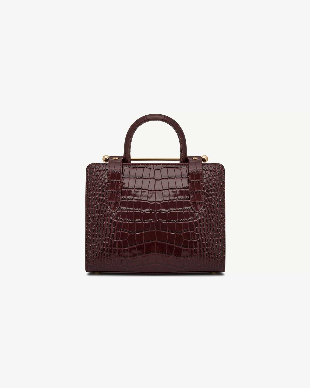 Mini tote in croc-embossed leather with a top handle and gold bar detail.
