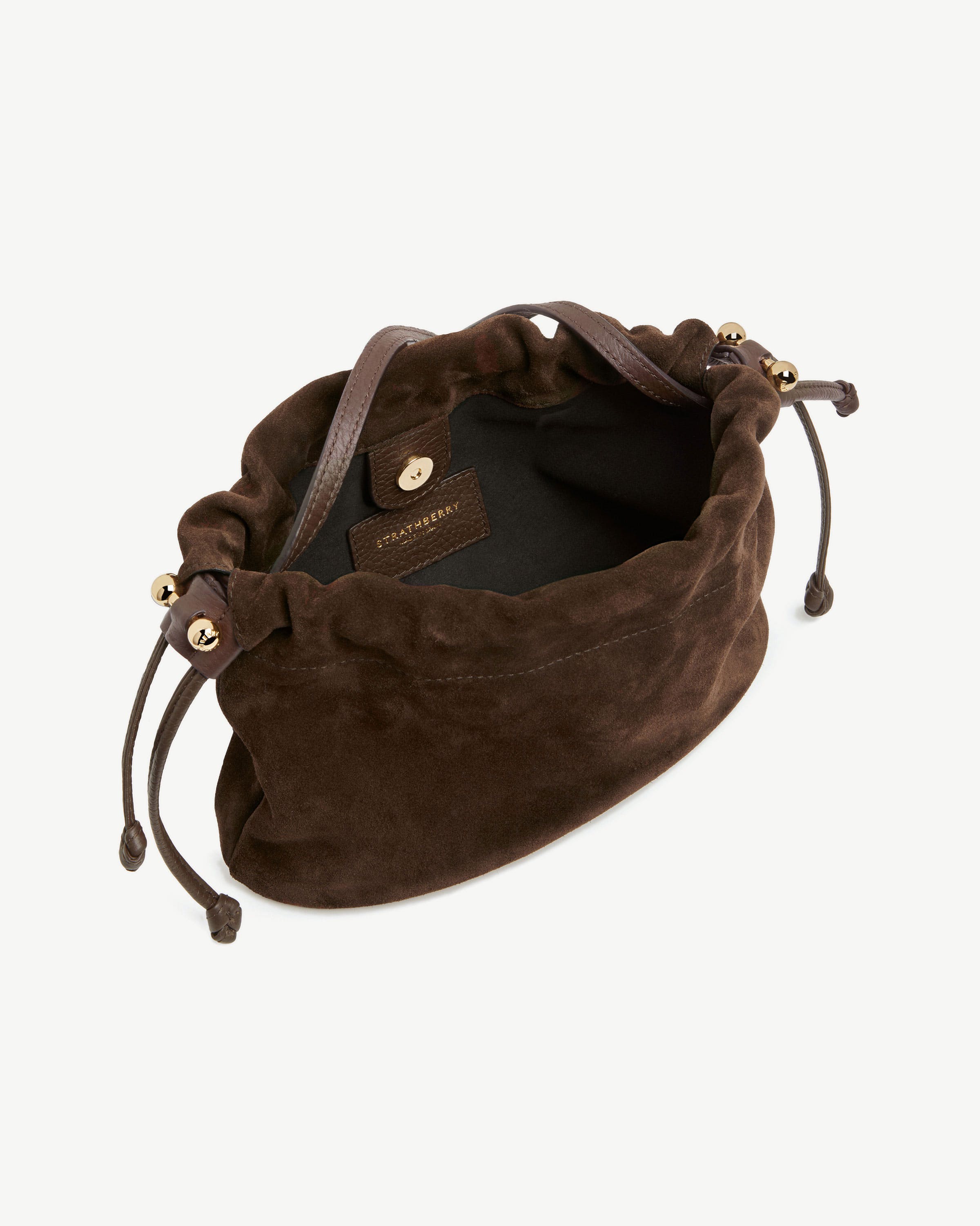 Strathberry chocolate suede Charlotte drawstring bag with leather strap and gold beads.