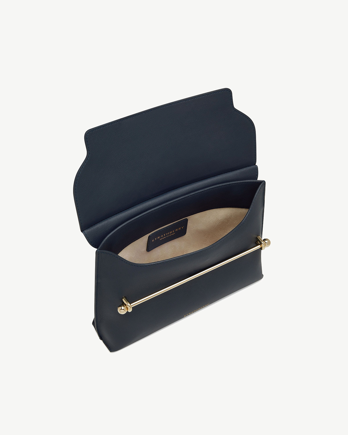 Marine blue Stylist bag with open flap showing Strathberry interior label and gold bar