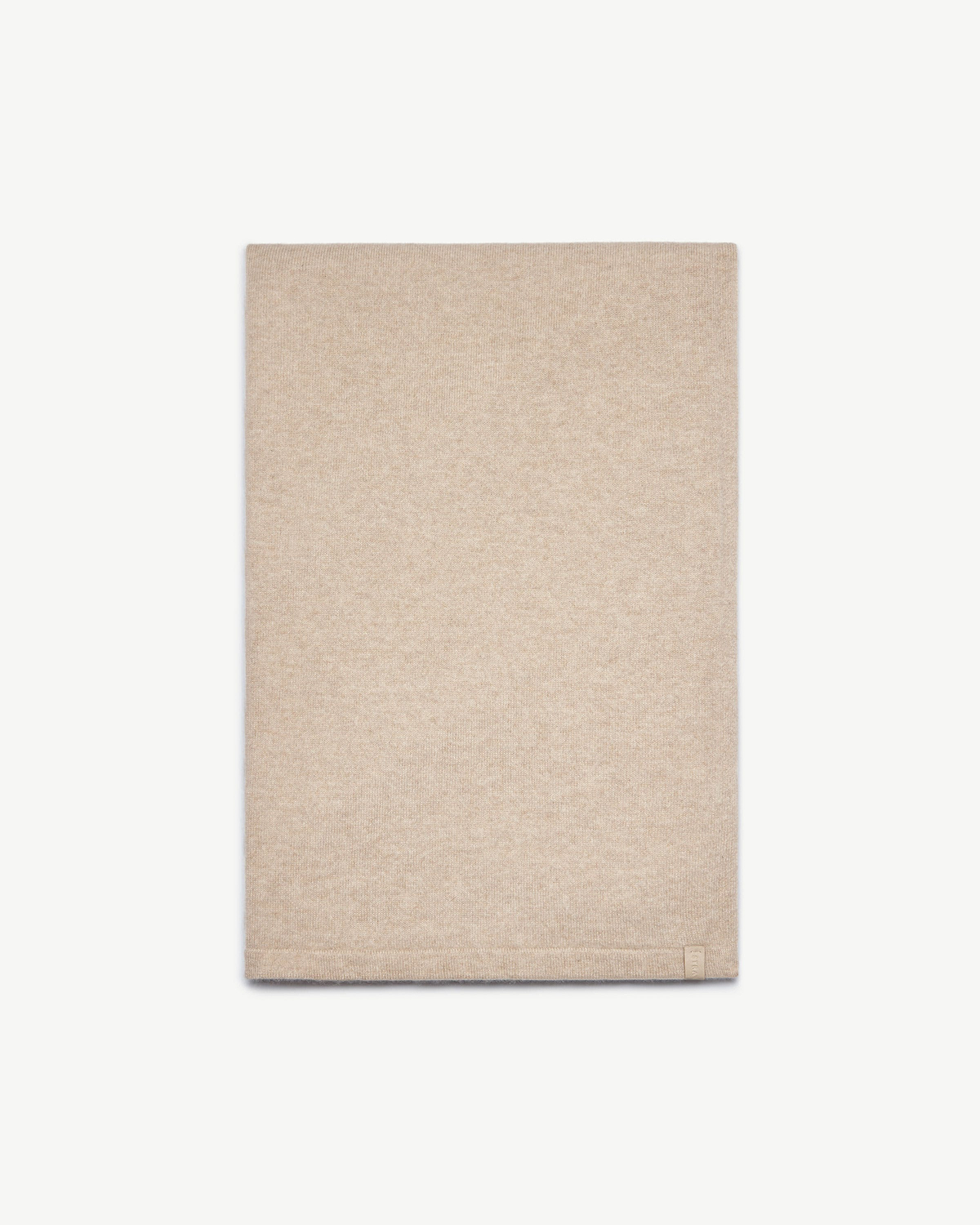 Oat cashmere travel wrap folded neatly on a white studio background.